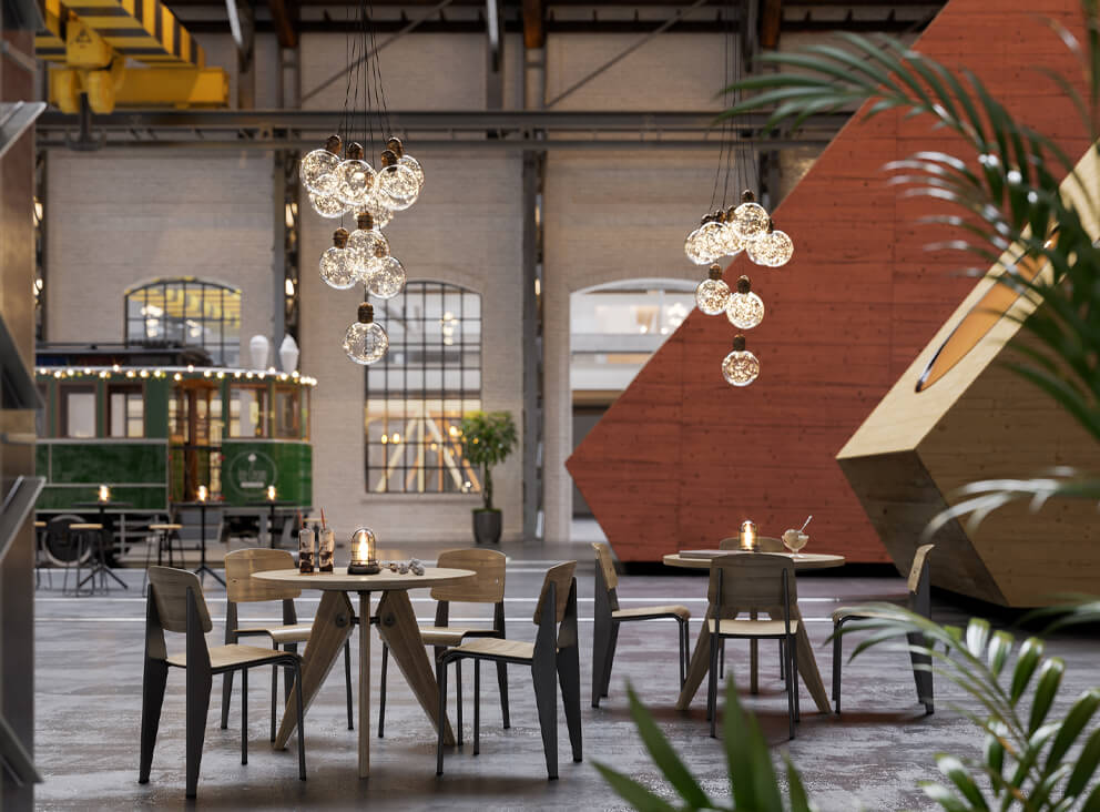 Innenansicht eines Restaurants mit Tischen und Stühlen, umgeben von einem stilvollen, industriellen Design.